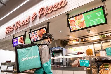 Deliveroo rider collects pizza from Sainsburys Hornsey