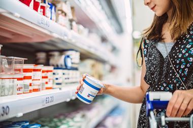 woman shopping for cream - getty