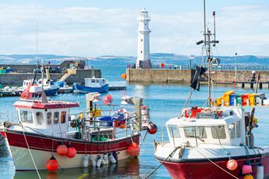 Fishing boats in Newhaven harbour,with Lighthouse behind,Edinburgh,Scotland,UK - Gettu