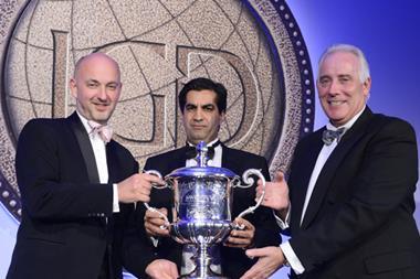 Adam Leyland (l) and Jim McCarthy (r) present The Grocer Cup to Ranjit Singh Boparan