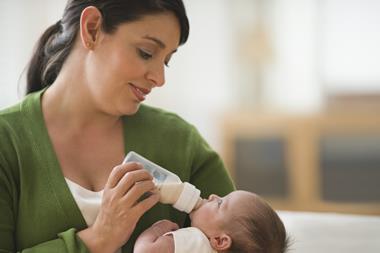 Mother bottle feeding baby