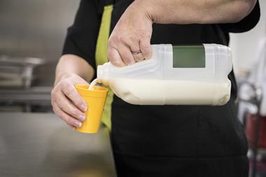 milk being poured into a cup