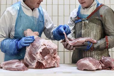 Butchery apprentice being coached