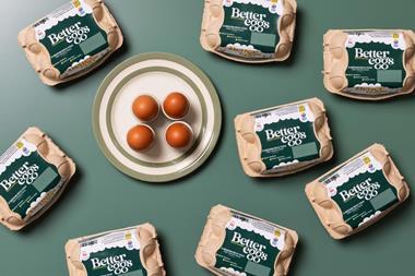 Egg boxes and eggs on green background