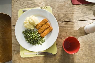 Fish fingers peas frozen food meal plate table