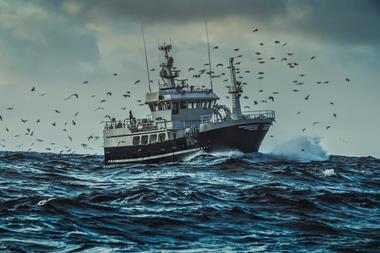 Fishing boat sailing at rough sea - stock photo - Getty Images