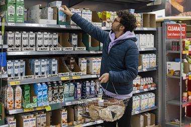 man browsing in dairy alternative milk aisle
