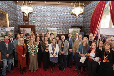 A group of people standing in a room marking the opening of an event