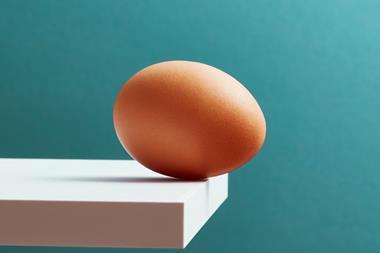 An egg teetering on the edge of a plank - stock photo - Getty Images