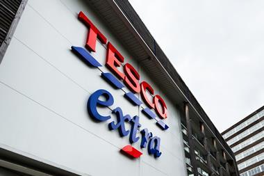 Tesco Extra exterior signage on a modern Manchester city building in the UK retail center - Getty