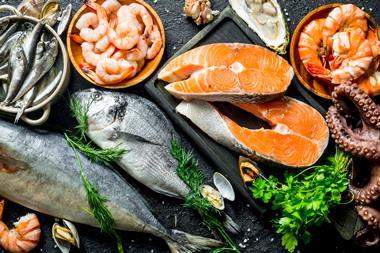 Fresh salmon steak with a variety of seafood and herbs - Getty