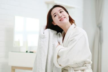 Woman drying hair with a towel