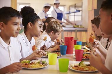 children eating school lunch - getty