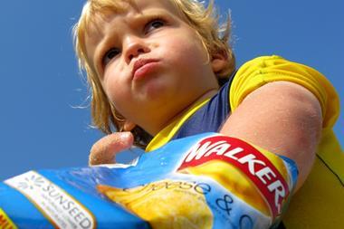 child eating crisps