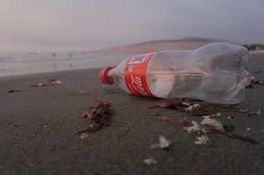 plastic coke bottle beach ocean