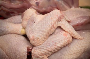 Butcher cutting organic chicken - getty