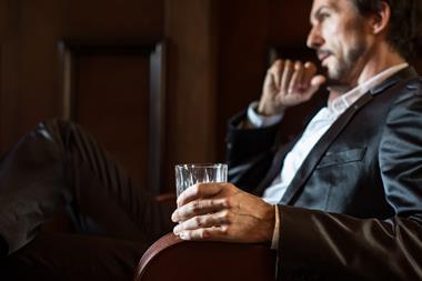 Man drinking whisky stock image