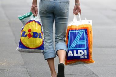 woman shopper with aldi and lidl carrier bags one use