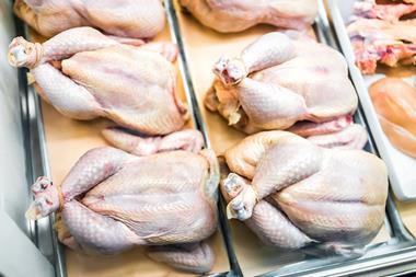 Raw whole chickens tied with string in butcher shop grocery store many uncooked skin closeup showing texture detail - stock photo