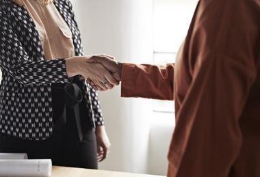 business meeting negotiation shake handshake agree GettyImages-1210790911