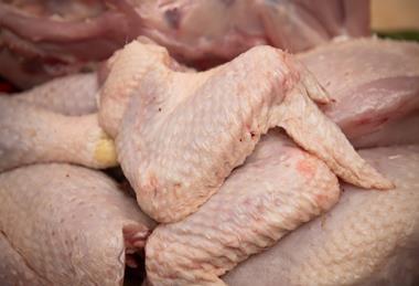 Butcher cutting organic chicken - getty