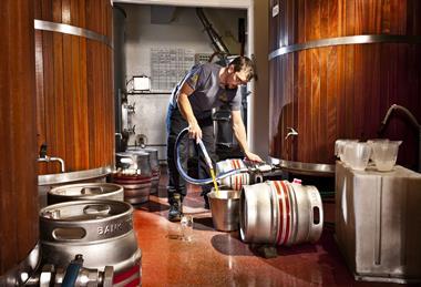 Brewery pouring beer away