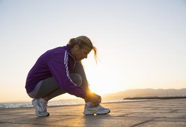 woman tying running shoes