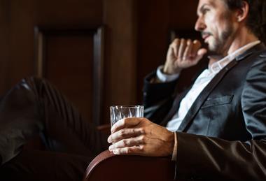 Man drinking whisky stock image