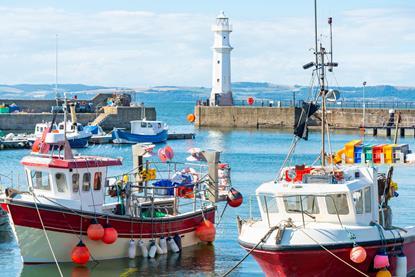 Fishing boats in Newhaven harbour,with Lighthouse behind,Edinburgh,Scotland,UK - Gettu
