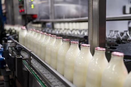 glass milk bottles on conveyor belt