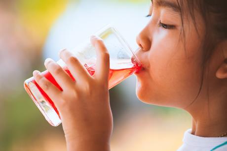 child drinking squash drink