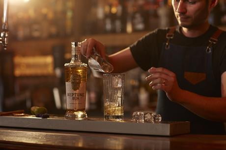 Neptune Gold on Bar Barman pouring ice