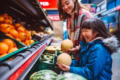 happy family fruit aisle supermarket shopper melon