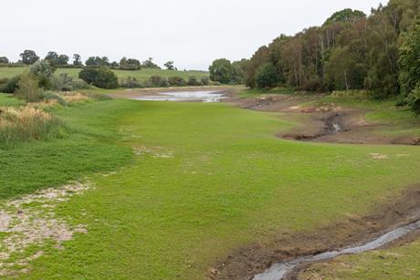 At the end of a dry summer, the water level of Staunton Harold Reservoir is very low, allowing grass to grow over the reservoir bed - The Grocer