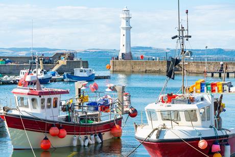 Fishing boats in Newhaven harbour,with Lighthouse behind,Edinburgh,Scotland,UK - Gettu