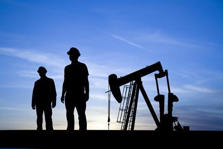 Oil pump and silhouettes of people