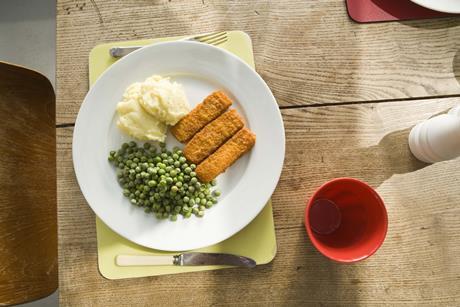 Fish fingers peas frozen food meal plate table