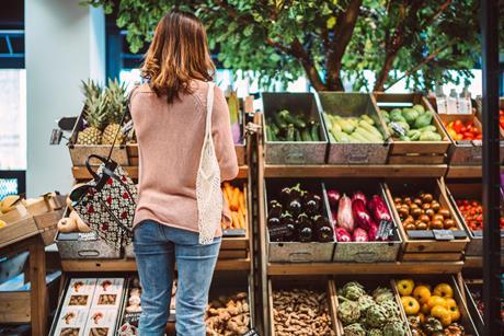 Woman shopping for fresh organic produce in a local grocery store - stock photo