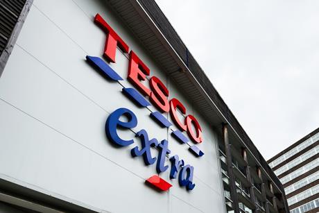 Tesco Extra exterior signage on a modern Manchester city building in the UK retail center - Getty