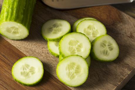 Cucumber cut up on a wooden chopping board