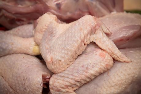 Butcher cutting organic chicken - getty