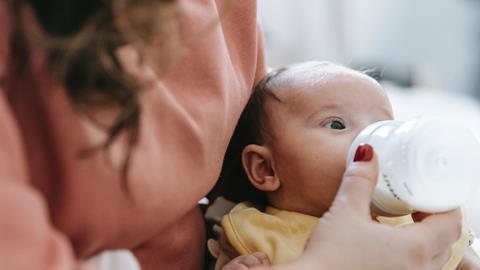 Mother feeding baby bottle