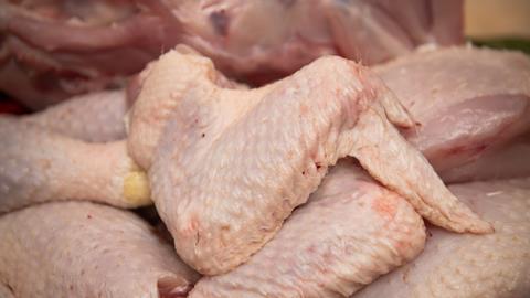 Butcher cutting organic chicken - getty