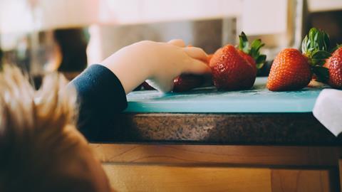 child eating fruit strawberries
