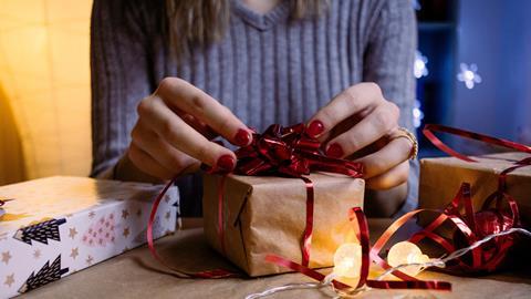 woman wrapping christmas present gift