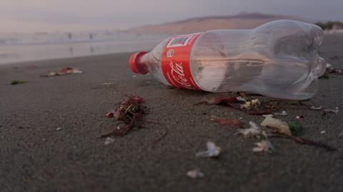 plastic coke bottle beach ocean