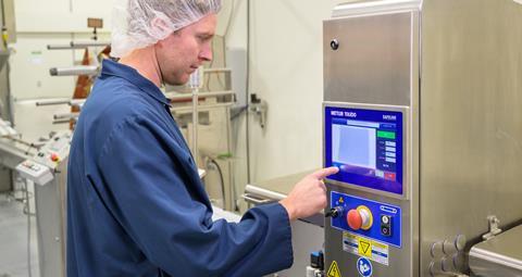 Man using a tech device, used for checking food contamination