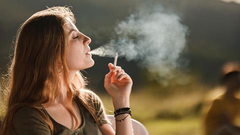 ypung woman smoking GettyImages-1262577833