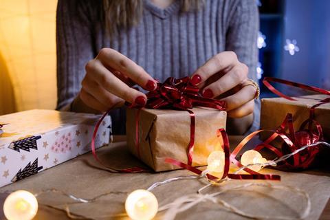 woman wrapping christmas present gift
