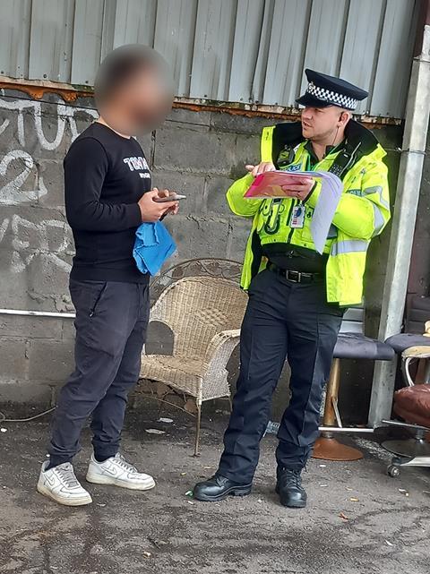 Cambridgeshire - Officer speaking to car wash worker
